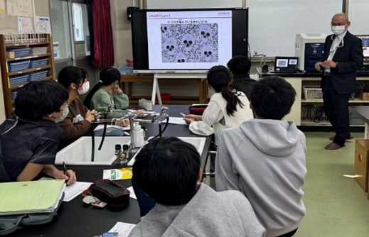 Students intently observing the samples reflected on the screen